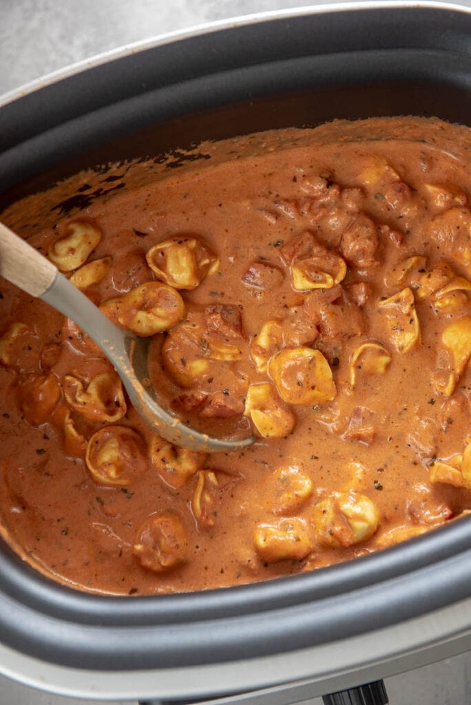slow cooker with tomato cream sauce and tortellini