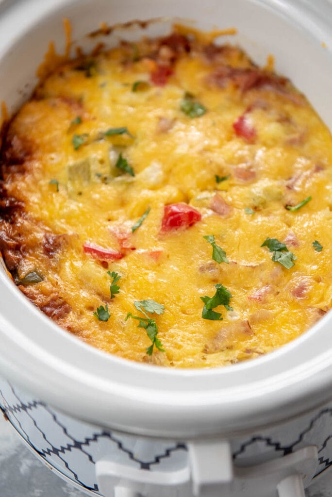 side view of cooked Denver omelette casserole in a white and blue slow cooker