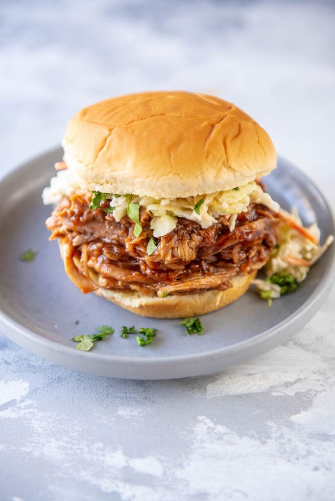 side view of bun filled with pulled pork and coleslaw