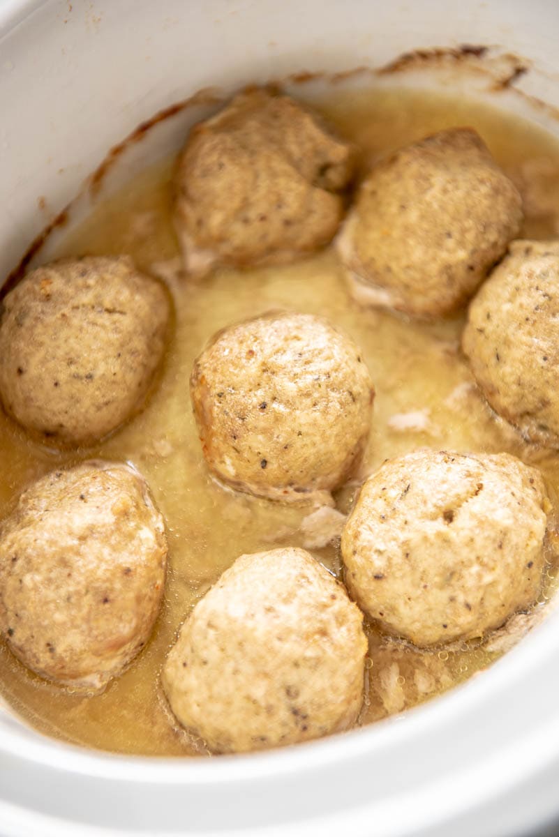turkey meatballs and sauce in a white slow cooker