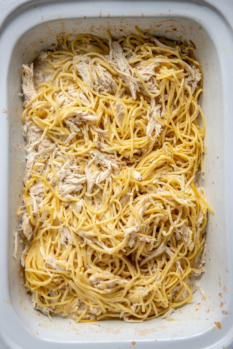 chicken, spaghetti, and spices in a slow cooker