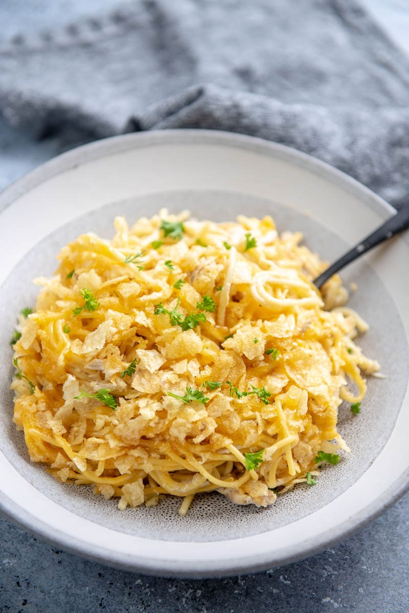 slow cooker chicken noodle casserole on white plate with spoon