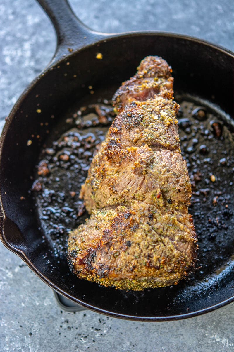 chuck roast browning in a cast iron skillet