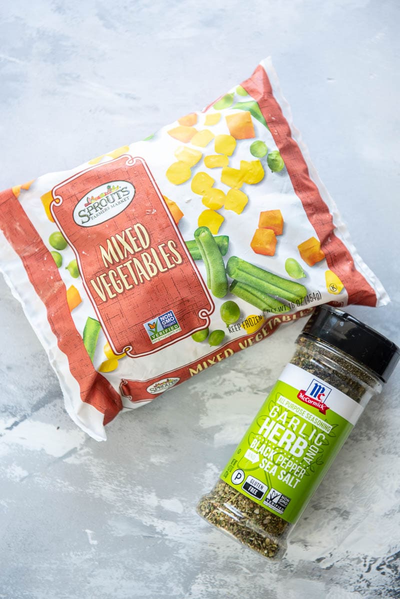bag of frozen mixed vegetables and bottle of herb and garlic seasoning