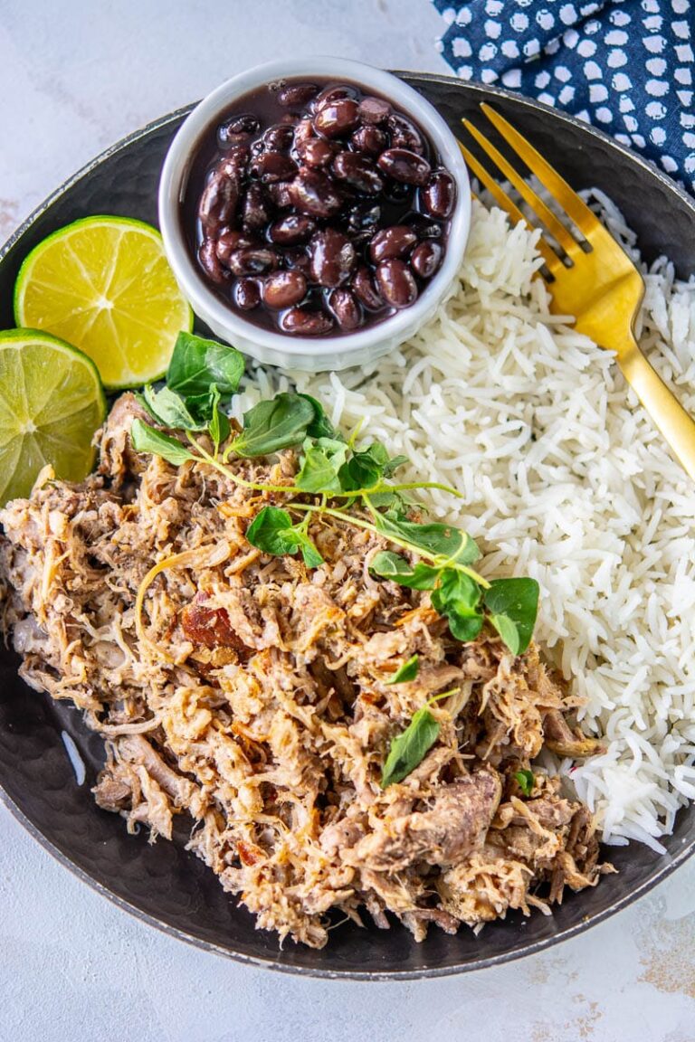 cuban pork on a plate with black beans and rice