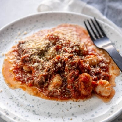 beef ragu on a white plate with fork