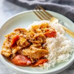 teriyaki chicken with rice on a plate with fork