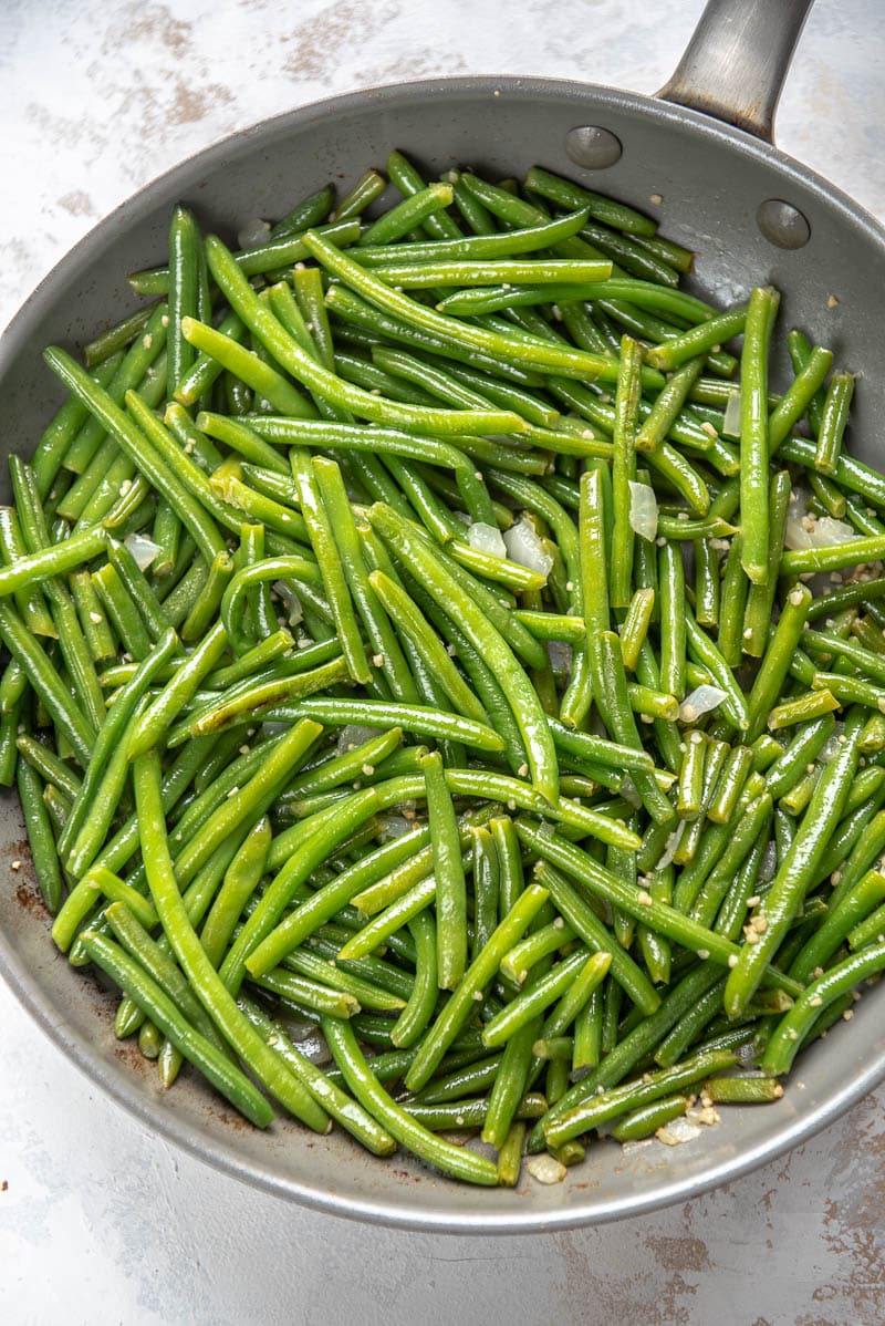 green beans garlic and seasonings in a skillet