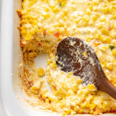 spoon scooping cheesy corn casserole