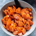 sauteed carrots in a bowl with spoon