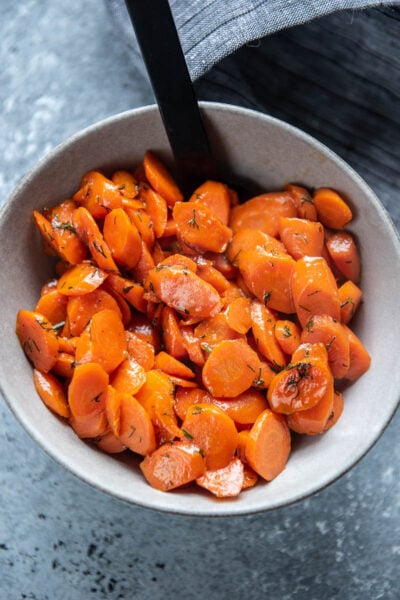 sauteed carrots in a bowl with spoon