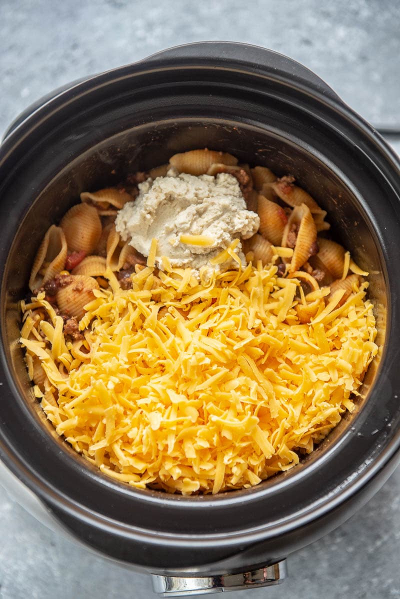 cheese topped taco pasta in a slow cooker