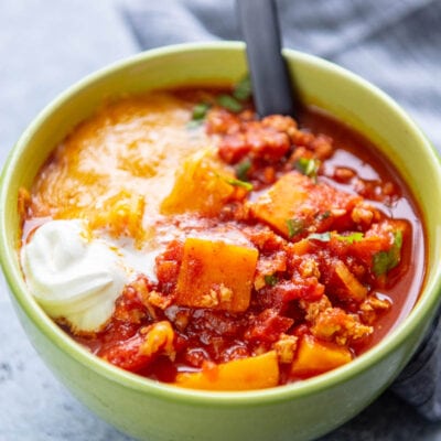 sweet potato and turkey chili in a bowl with spoon