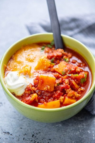 sweet potato and turkey chili in a bowl with spoon