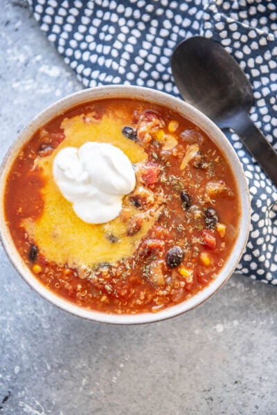 bowl of chili topped with cheese and sour cream