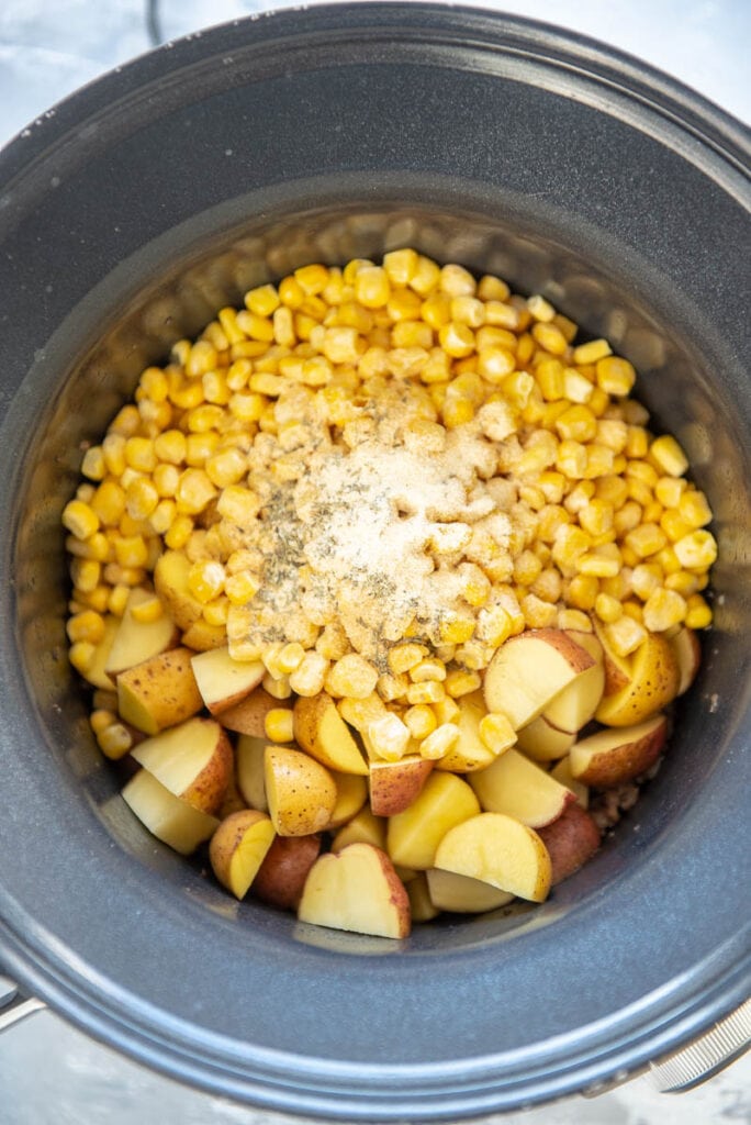 corn and potatoes in round slow cooker