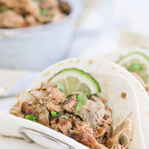 carnitas with lime on a plate