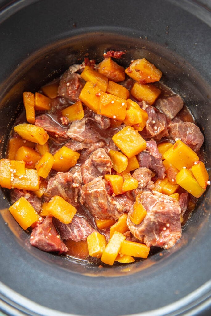 stew meat and butternut squash in a slow cooker