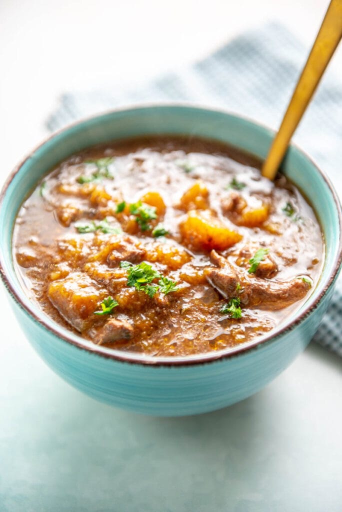 beef and butternut squash stew in bowl with spoon