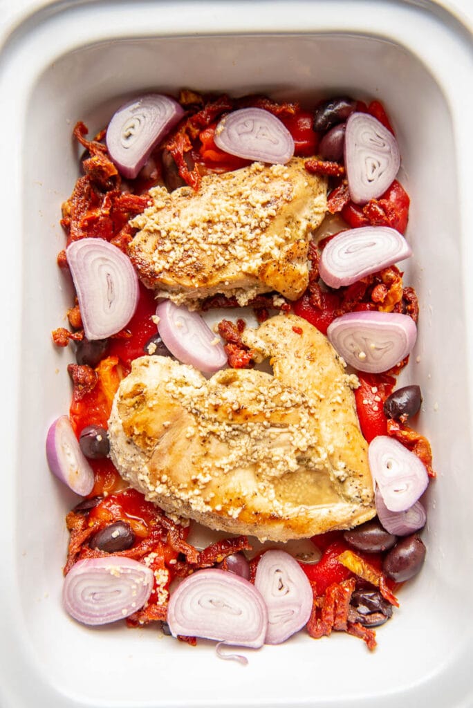 browned chicken and greek seasonings in a slow cooker