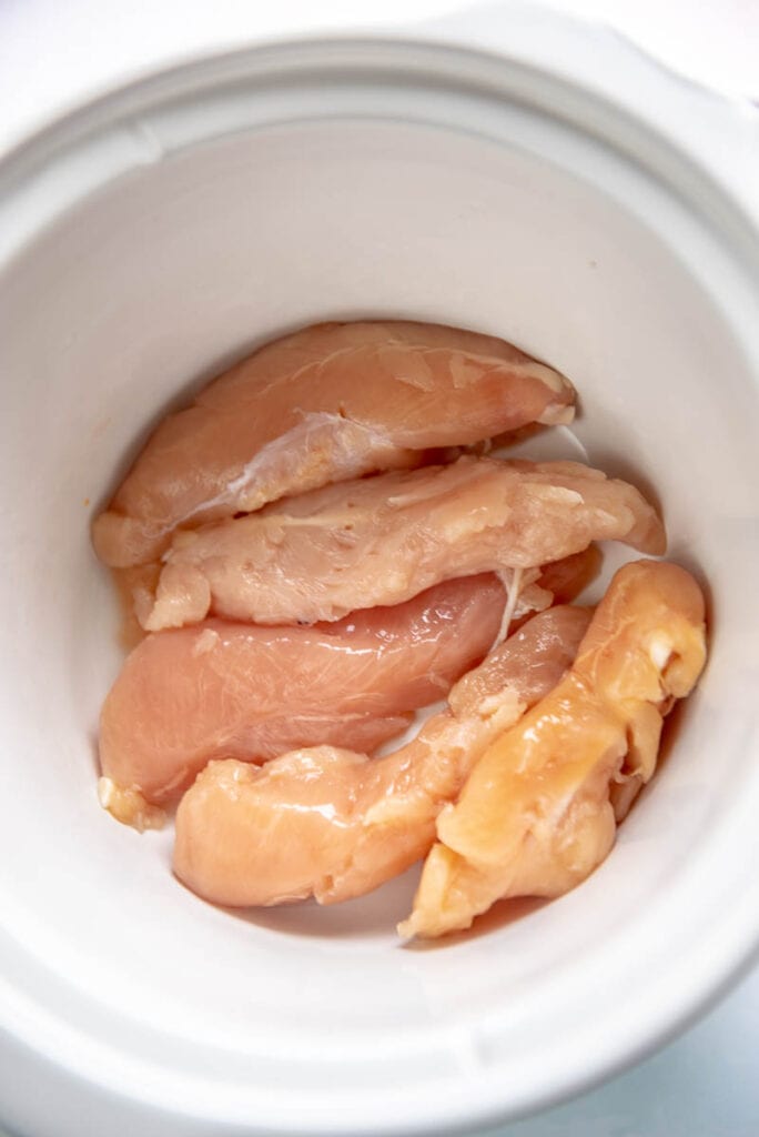 raw chicken breasts in a slow cooker