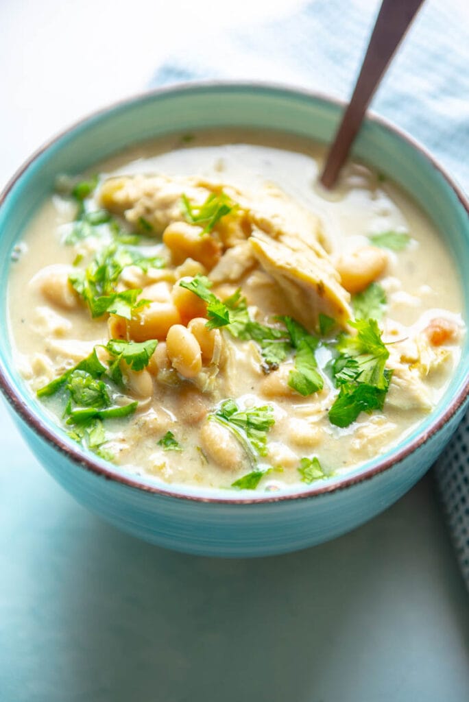 white chicken chili and garnish in a bowl with spoon