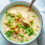 white chicken chili in a bowl with spoon