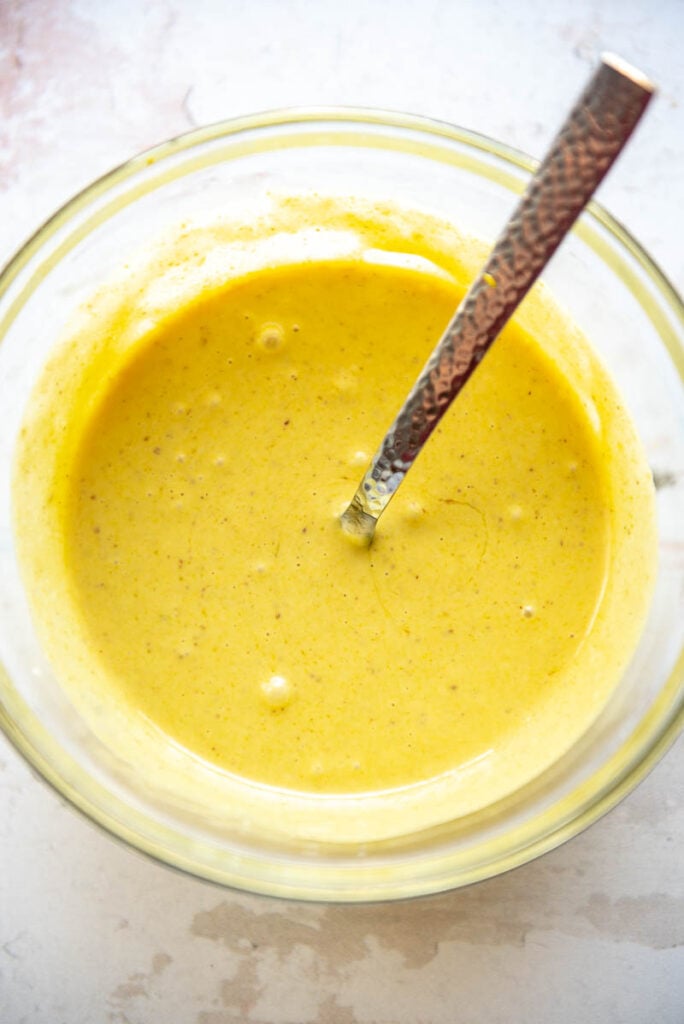 honey mustard sauce in a bowl with spoon