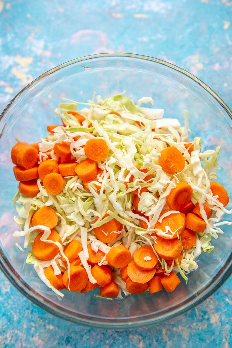 shredded cabbage and sliced carrots in glass bowl