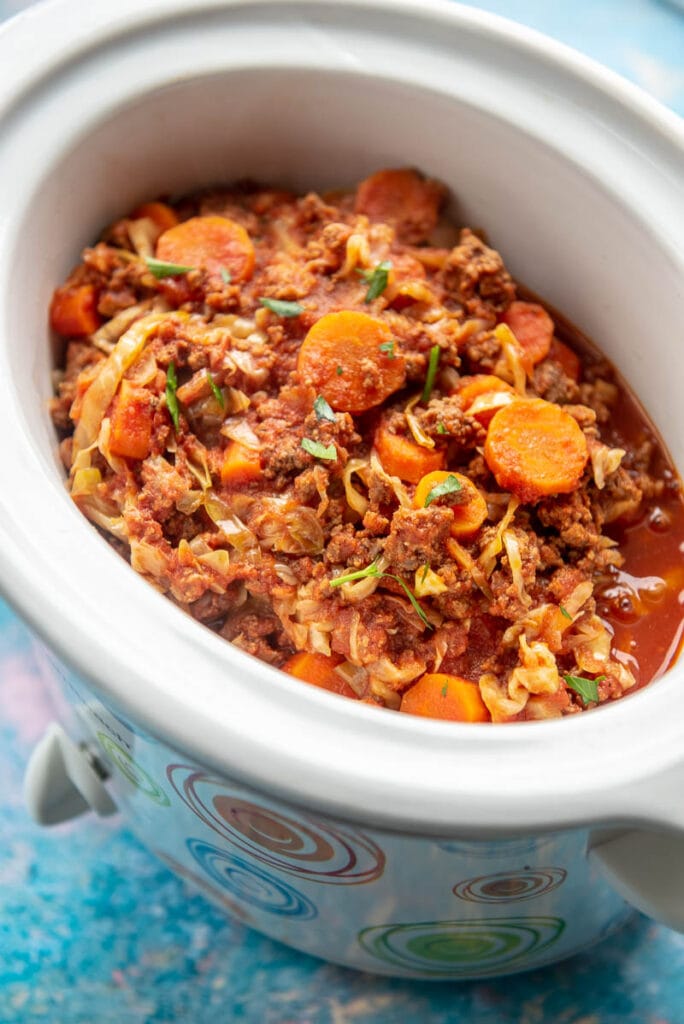 slow cooker filled with beef and cabbage casserole