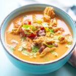 blue bowl filled with creamy chicken enchilada soup