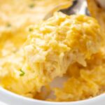 large spoonful of hash brown casserole over slow cooker
