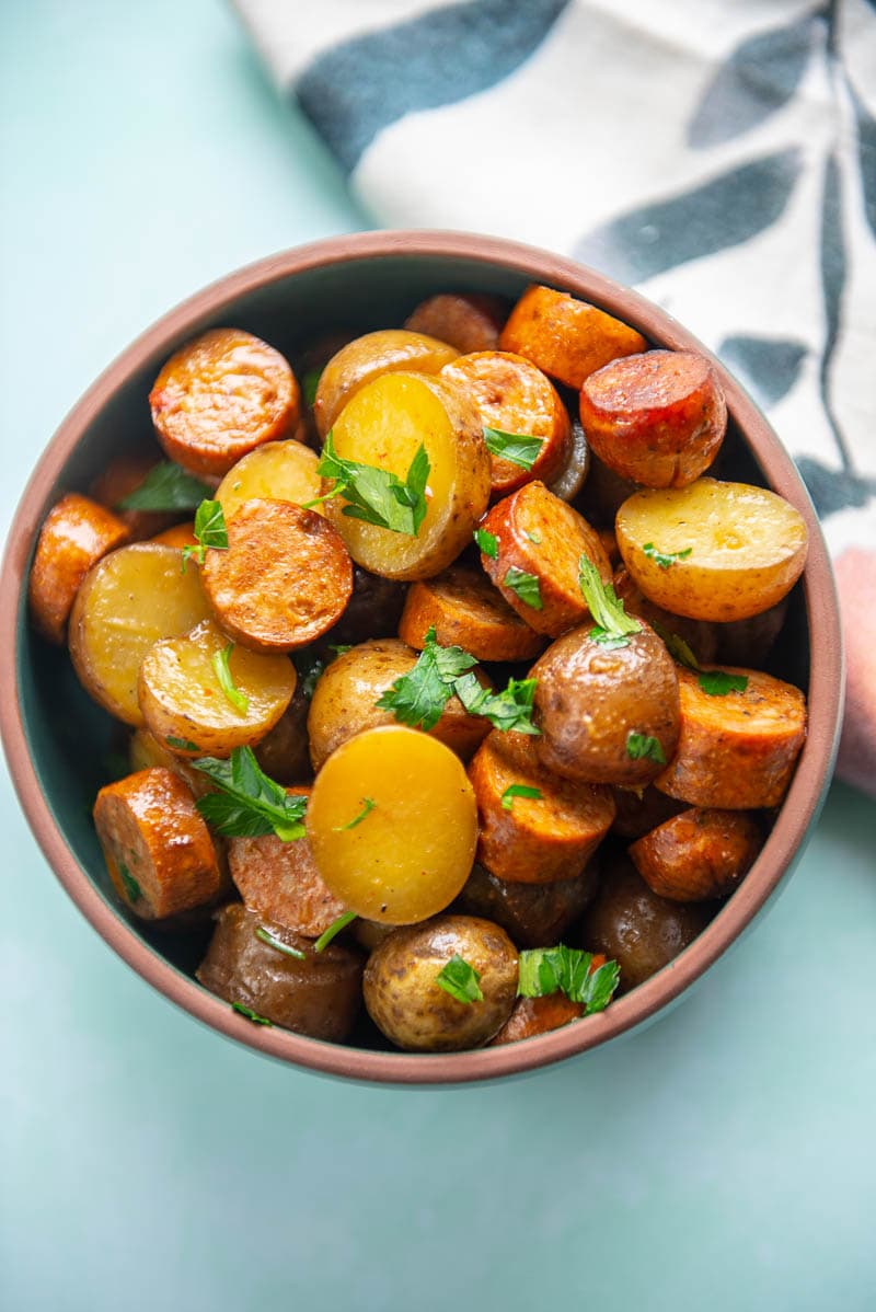 sliced sausage and seasoned potatoes in bowl