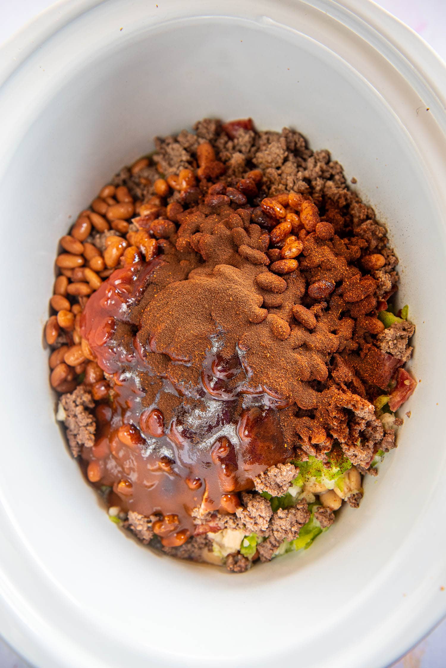 beans, meat, sauce and seasoning in slow cooker