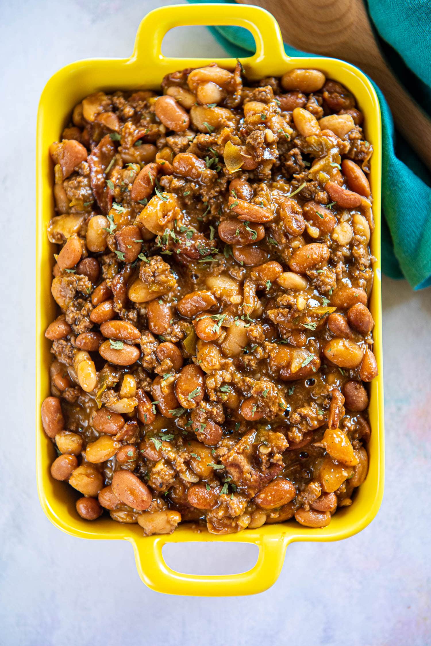 cowboy beans in yellow casserole dish