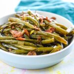 cooked fresh green beans in serving bowl with bacon