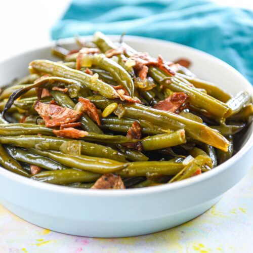 cooked fresh green beans in serving bowl with bacon