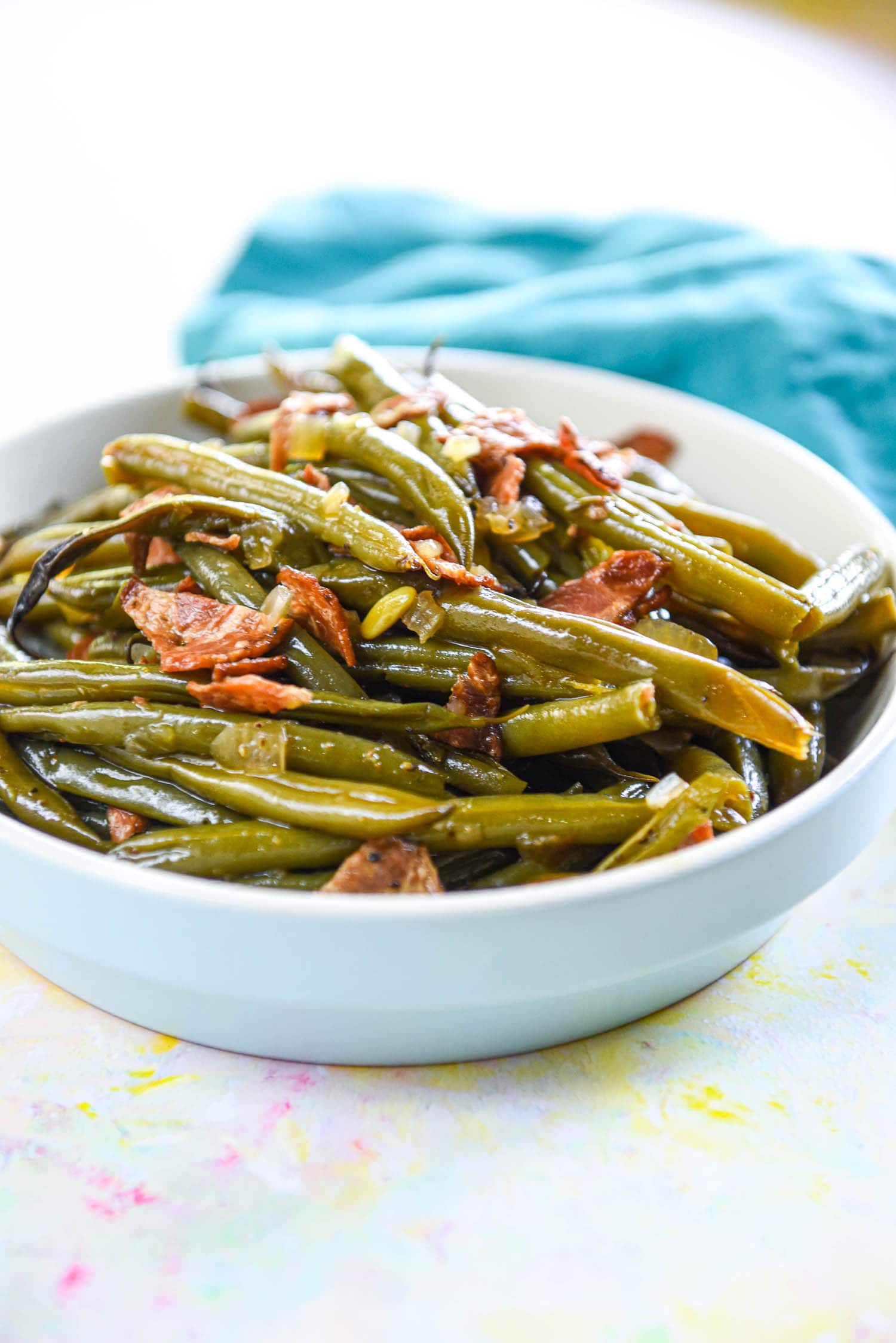 cooked fresh green beans in serving bowl with bacon