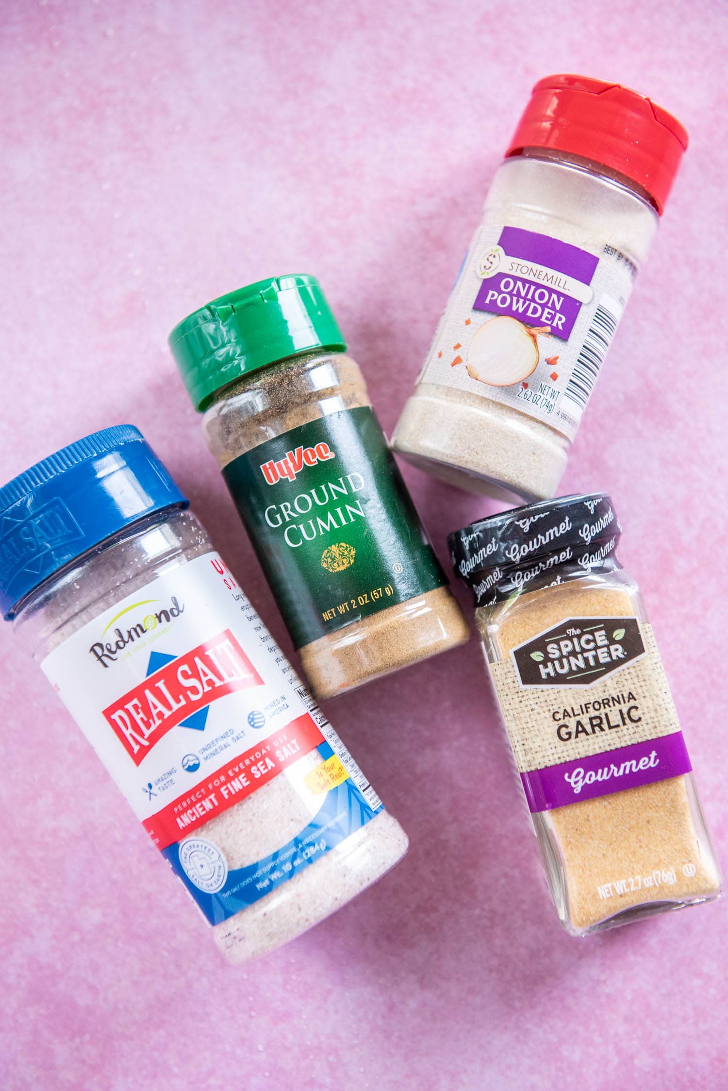 salt, cumin, onion powder and garlic powder seasoning bottles