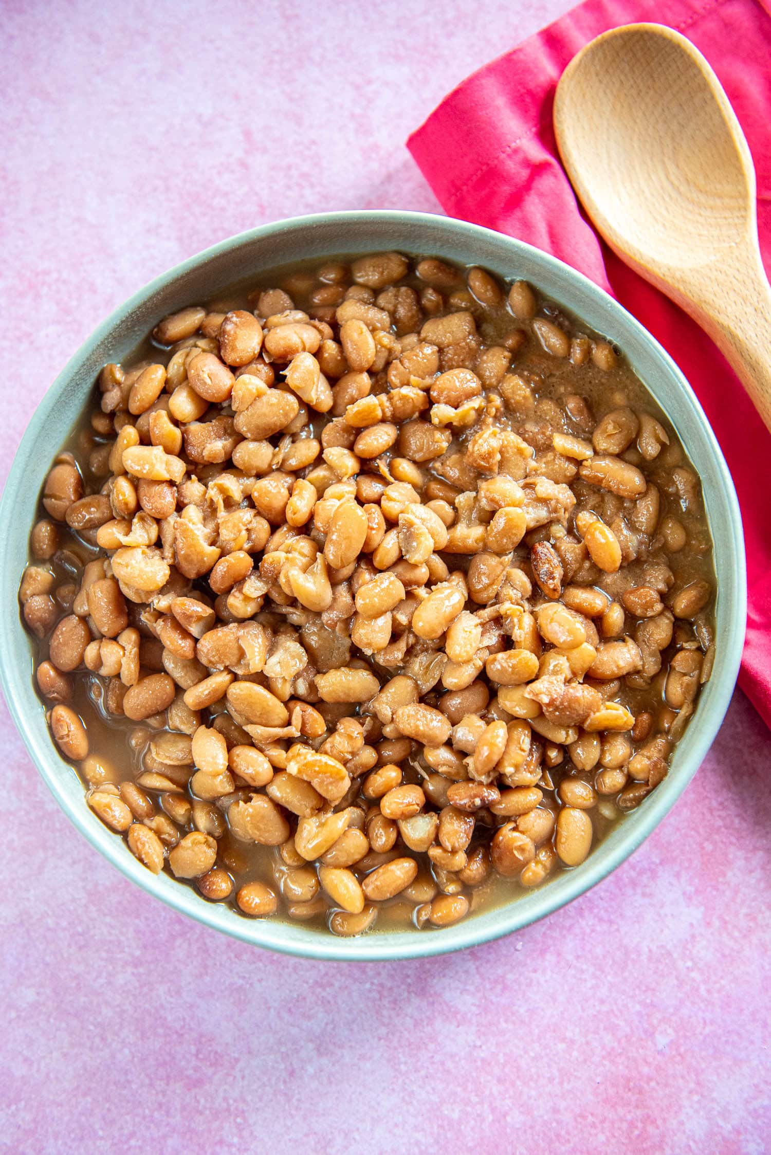 cooked pinto beans in gray serving bowl