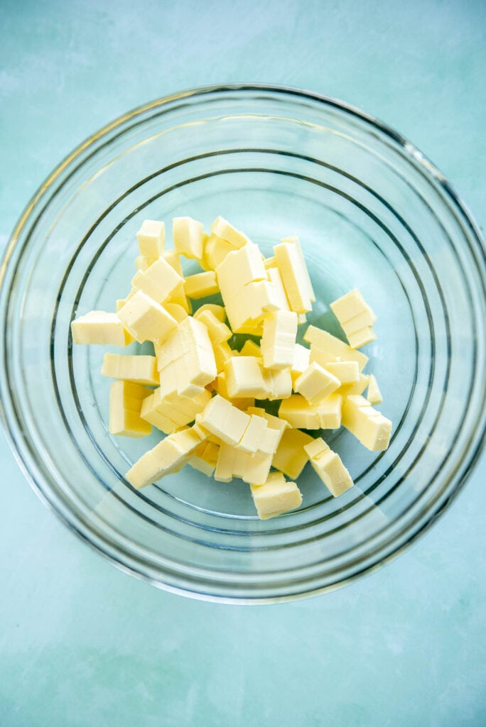 glass bowl with chopped up butter