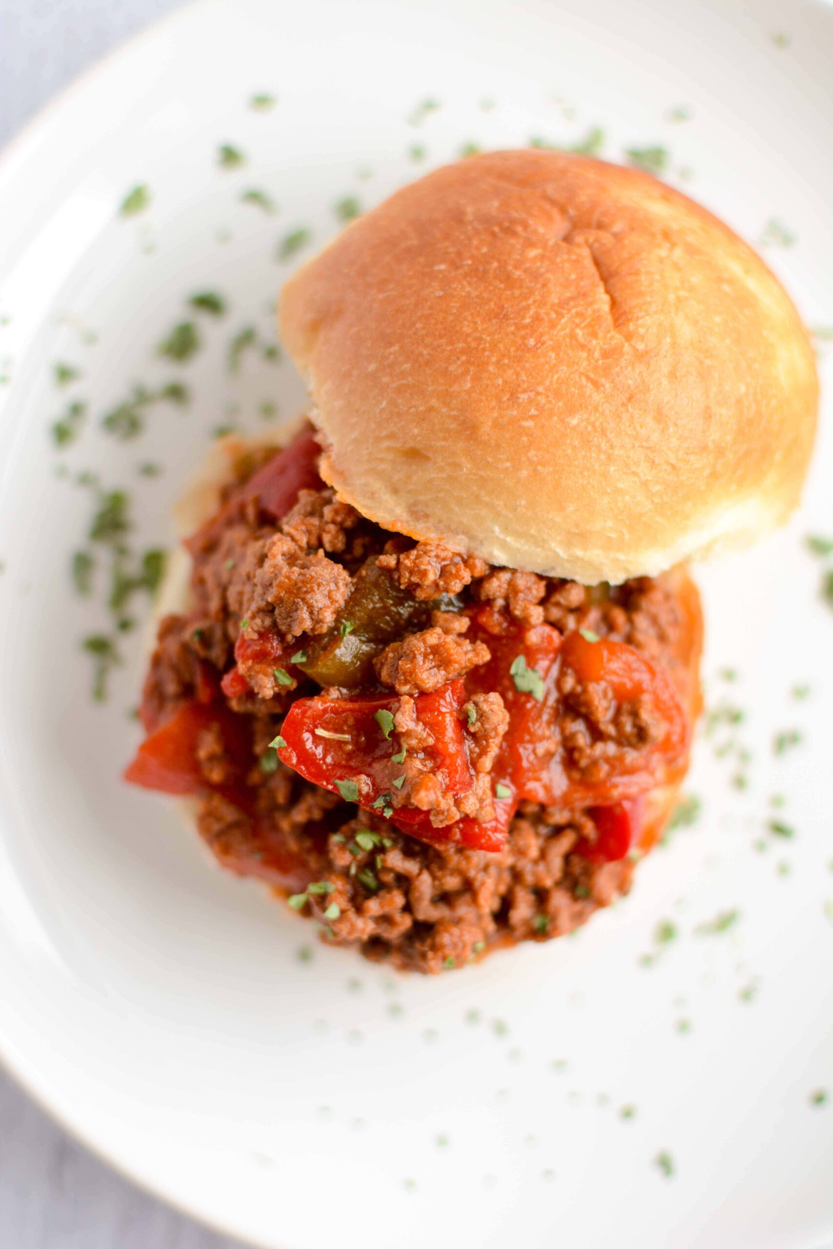 sloppy Joe on open bun on white plate