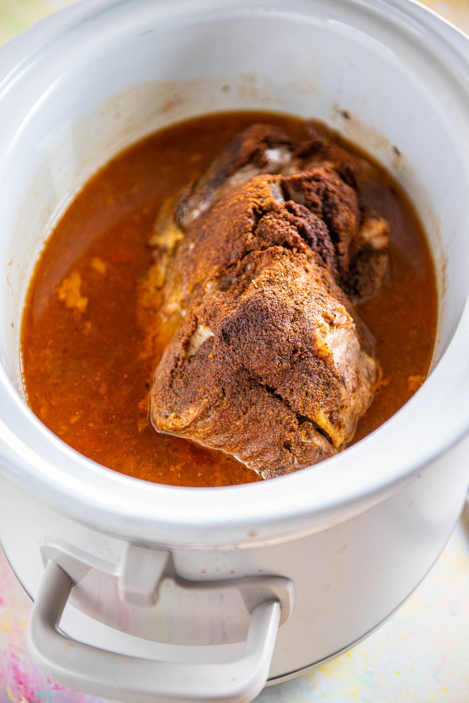 pork shoulder in slow cooker with juices