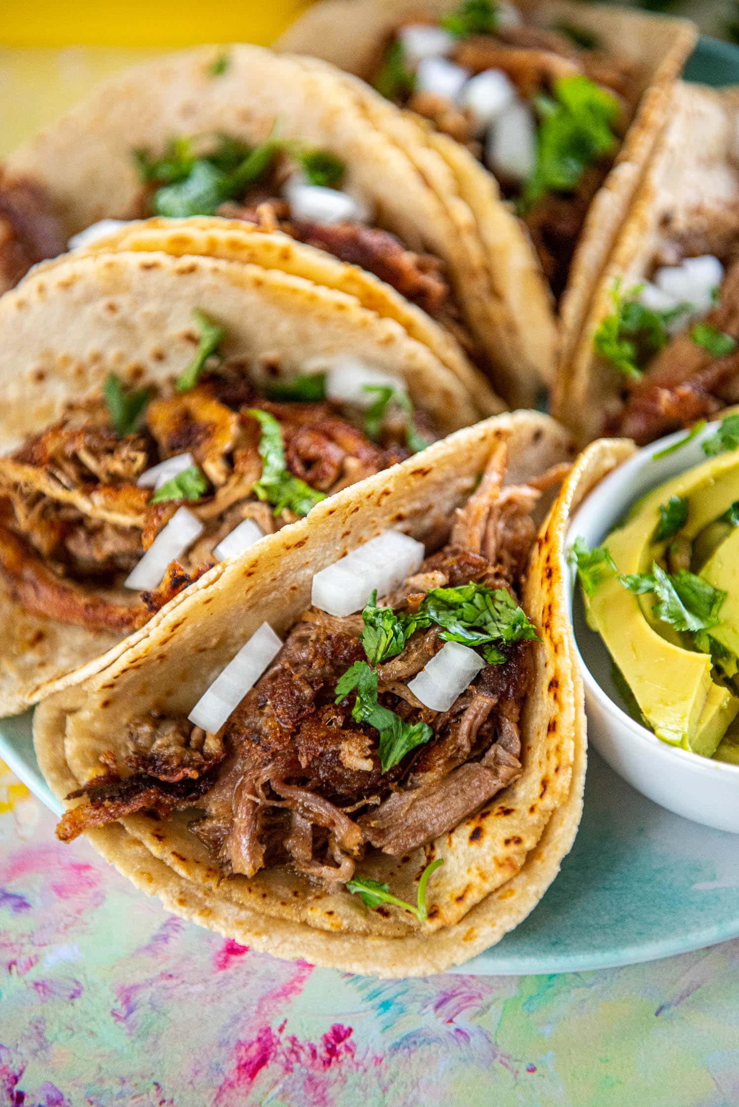 close up of the inside of a carnitas street taco with onions and cilantro