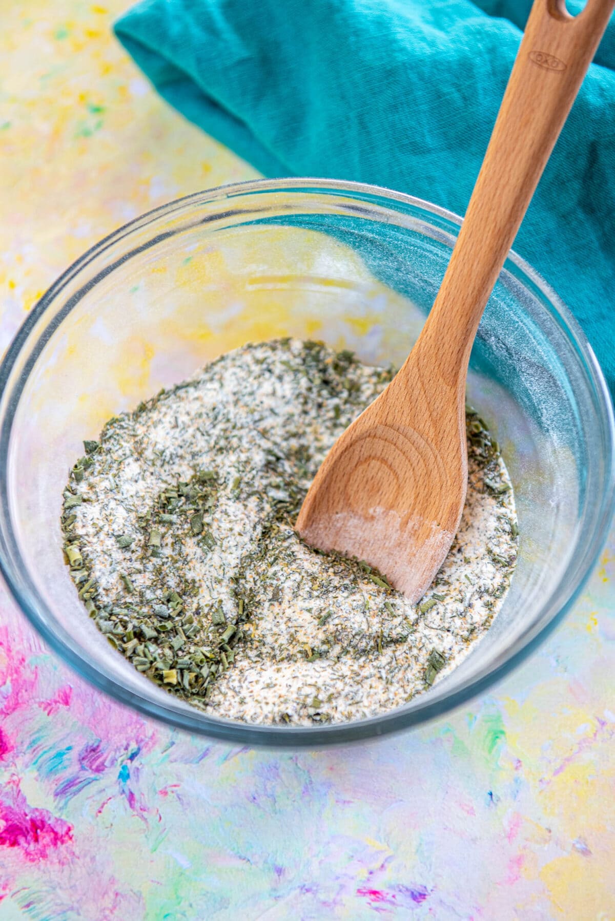 glass bowl filled with ranch dressing mix with wood spoon