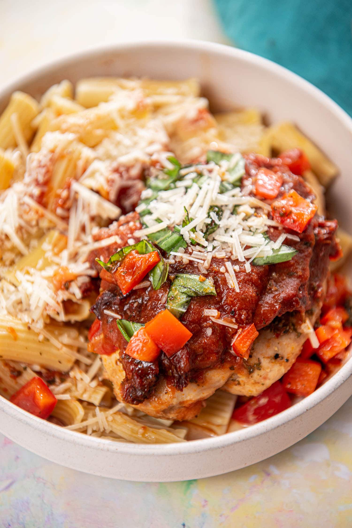 chicken breast with Italian seasoning topped with marinara and tomatoes over pasta