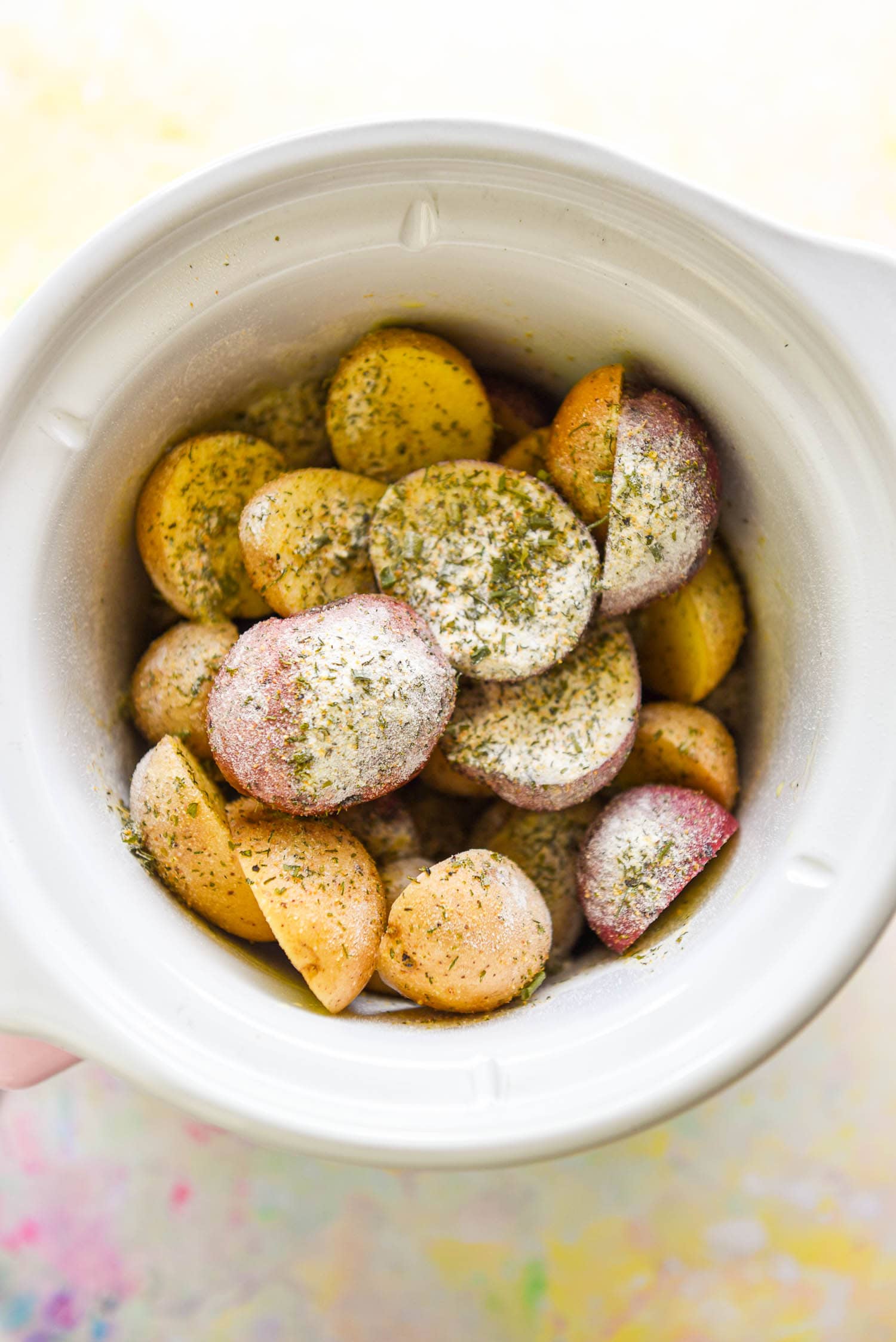 raw baby potatoes halved and seasoned in slow cooker
