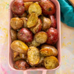 roasted potatoes with ranch seasoning in pink casserole dish