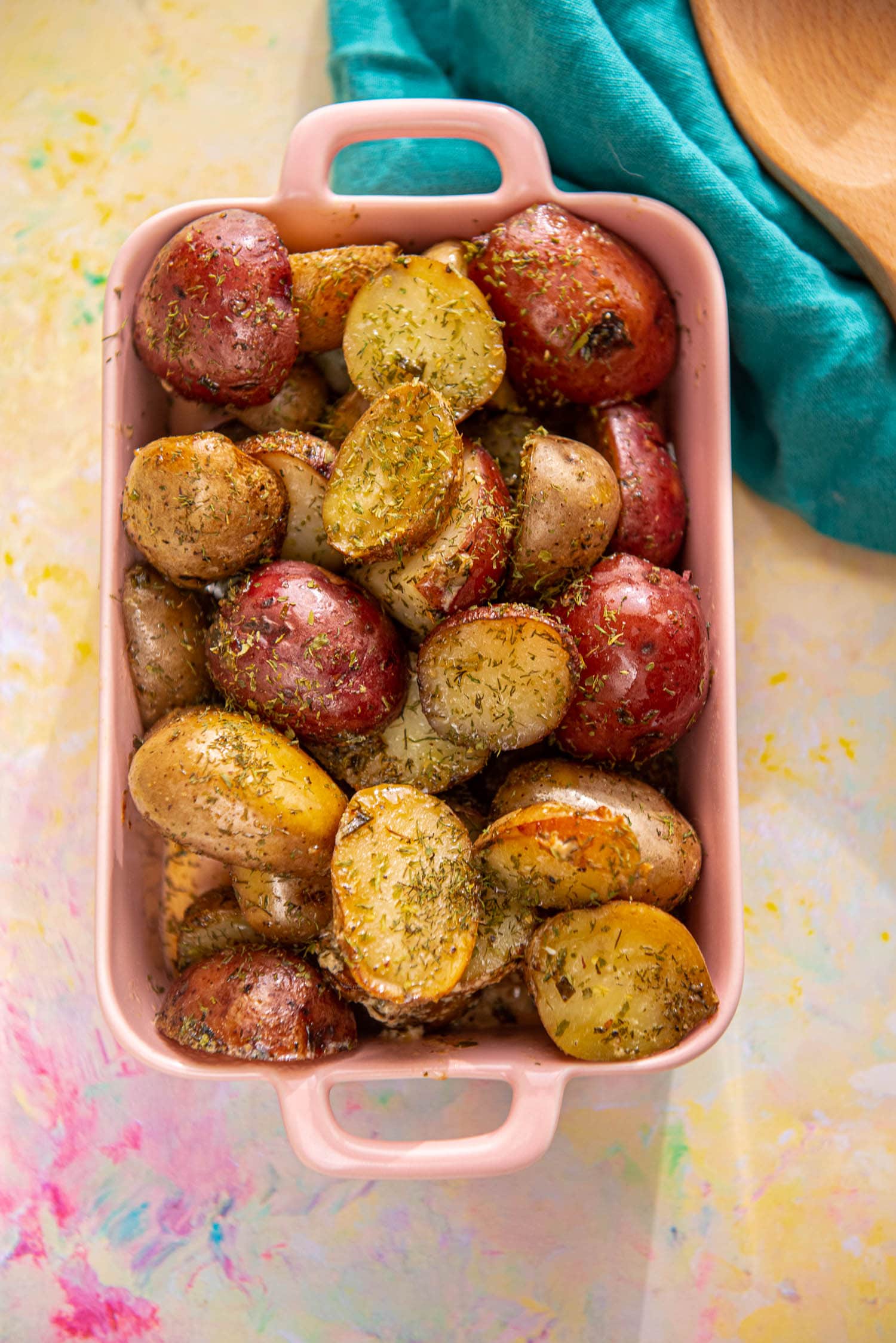 roasted potatoes with ranch seasoning in pink casserole dish