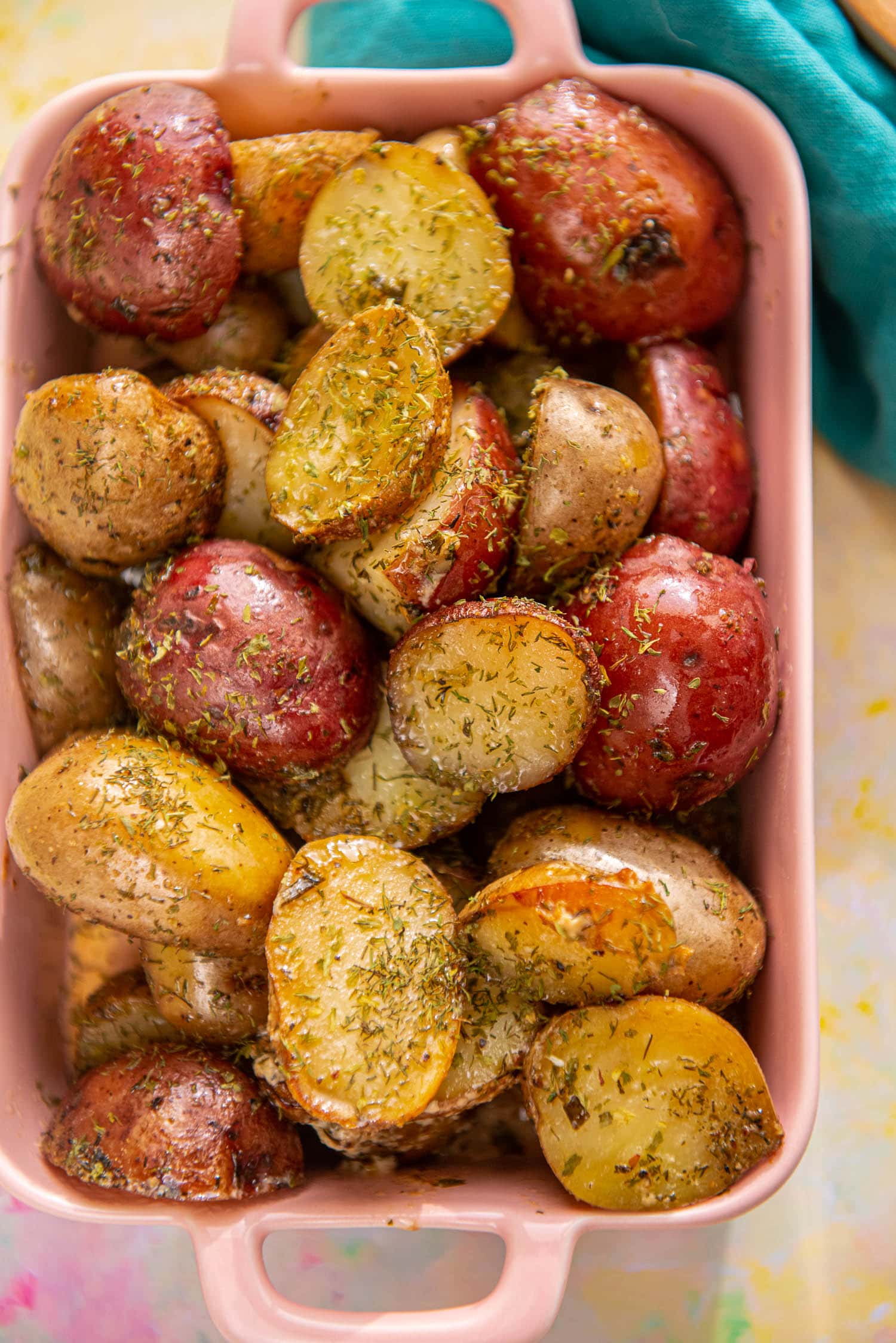 seasoned baby potatoes in pink casserole dish